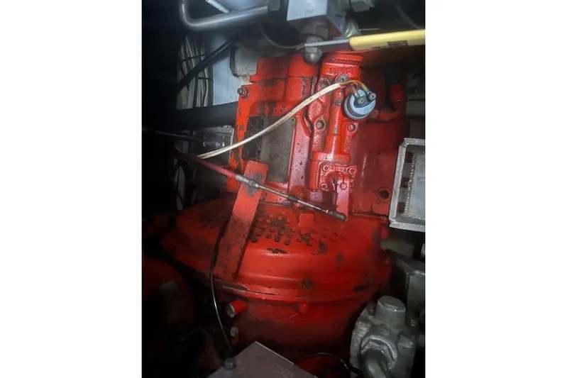 Bad Habits Yacht Photos Pics Engine compartment of a 2002 Libby 38 Downeast boat, featuring red mechanical components.