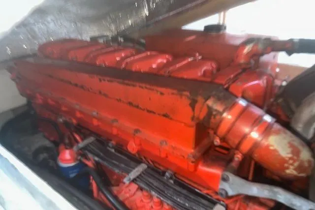 Bad Habits Yacht Photos Pics Red engine of a 2002 Libby 38 Downeast boat, showcasing detailed components.