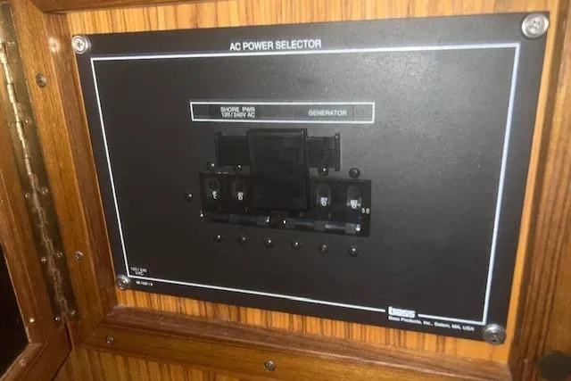 Bad Habits Yacht Photos Pics AC power selector panel on 2002 Libby 38 Downeast boat, featuring generator and shore power options.