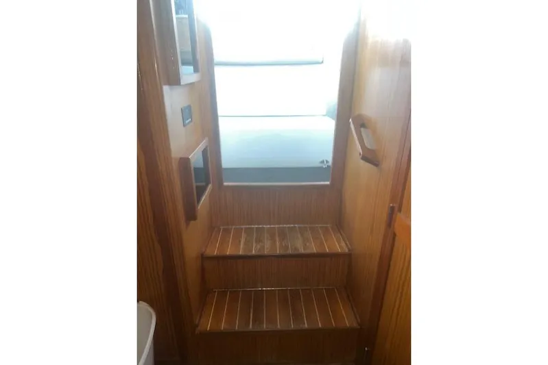 Bad Habits Yacht Photos Pics Wooden interior stairs of 2002 Libby 38 Downeast boat, leading to upper deck.