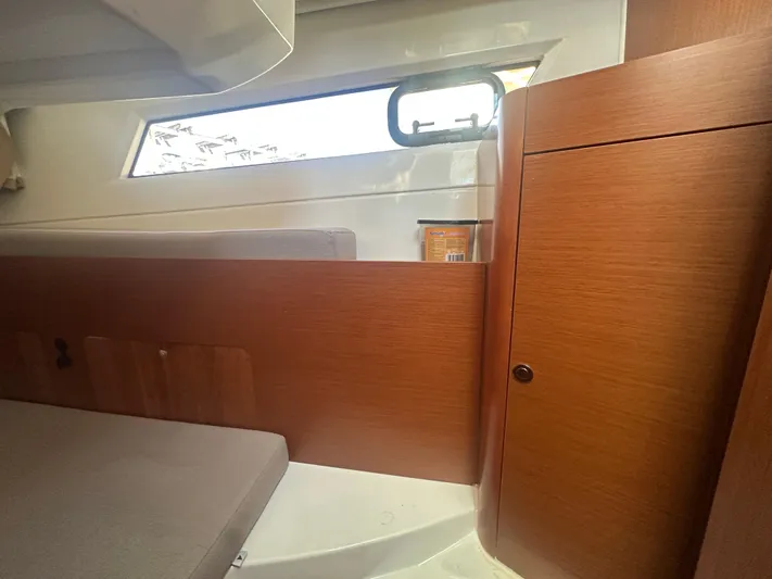 Marking Time Yacht Photos Pics Interior of 2016 Jeanneau Merry Fisher 855, featuring wooden cabinetry and a window.