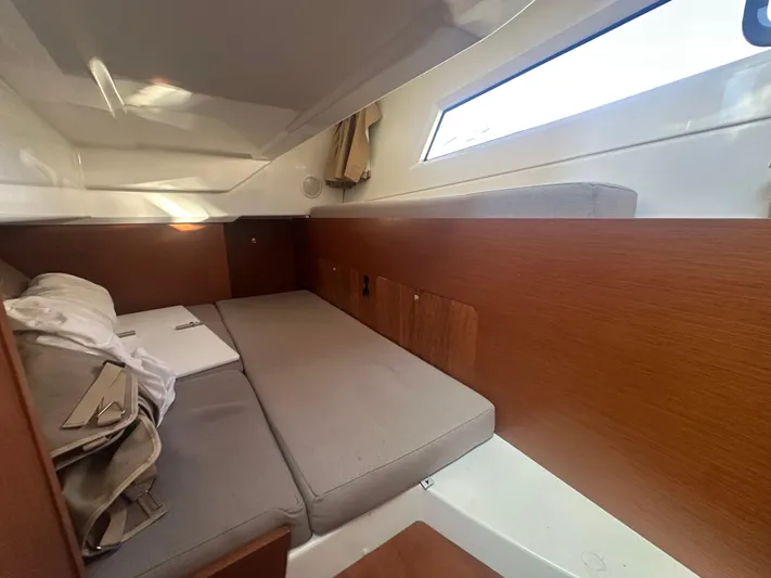 Marking Time Yacht Photos Pics Interior cabin of 2016 Jeanneau Merry Fisher 855 with cozy seating and wooden accents.