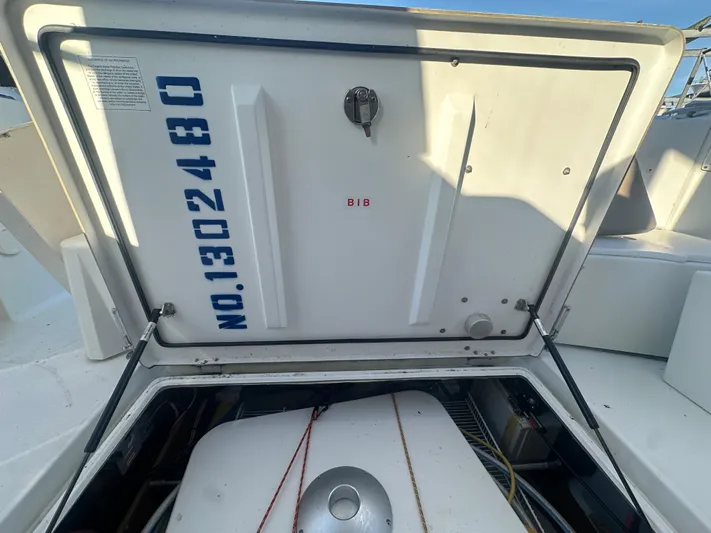 Marking Time Yacht Photos Pics Open hatch on 2016 Jeanneau Merry Fisher 855 boat, revealing storage compartment.