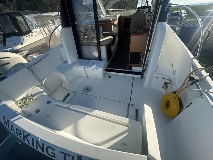 Marking Time Yacht Photos Pics 2016 Jeanneau Merry Fisher 855 boat interior with seating and helm.