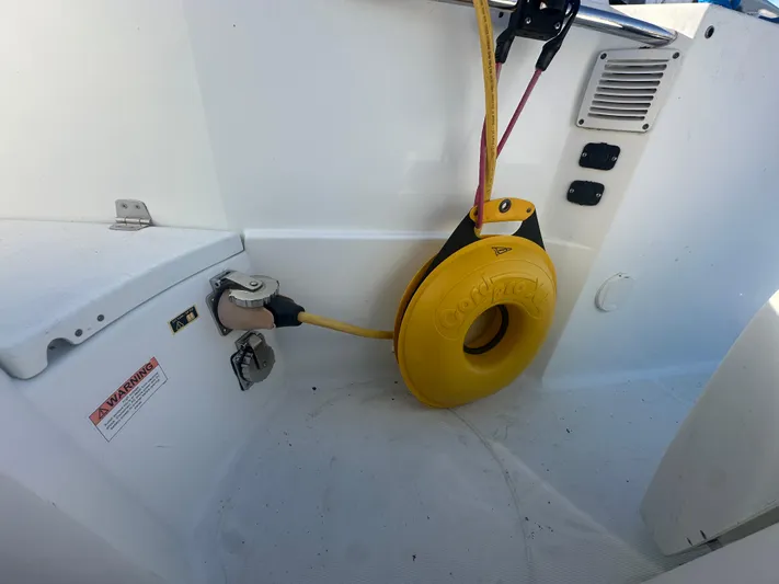 Marking Time Yacht Photos Pics 2016 Jeanneau Merry Fisher 855 boat deck with power connections and safety equipment.