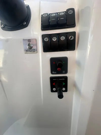 Marking Time Yacht Photos Pics Control panel of 2016 Jeanneau Merry Fisher 855 boat with switches and joystick.