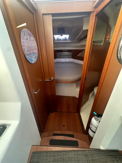 Marking Time Yacht Photos Pics Interior view of 2016 Jeanneau Merry Fisher 855 boat cabin with wood finish.