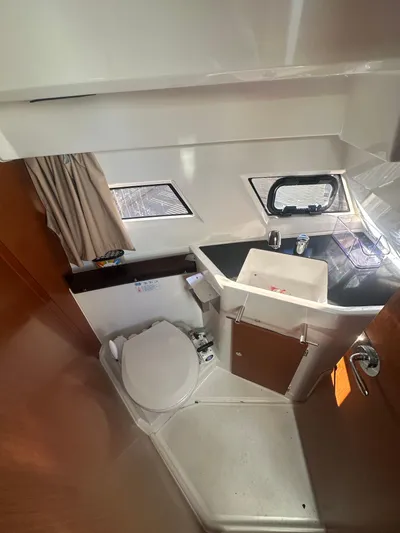 Marking Time Yacht Photos Pics 2016 Jeanneau Merry Fisher 855 bathroom with sink, toilet, and window.