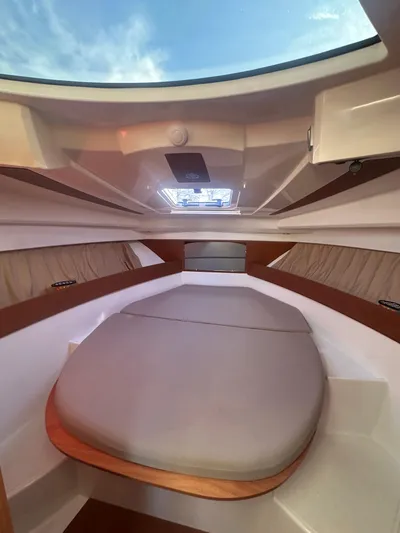 Marking Time Yacht Photos Pics Interior cabin of 2016 Jeanneau Merry Fisher 855 with skylight and cozy bed.