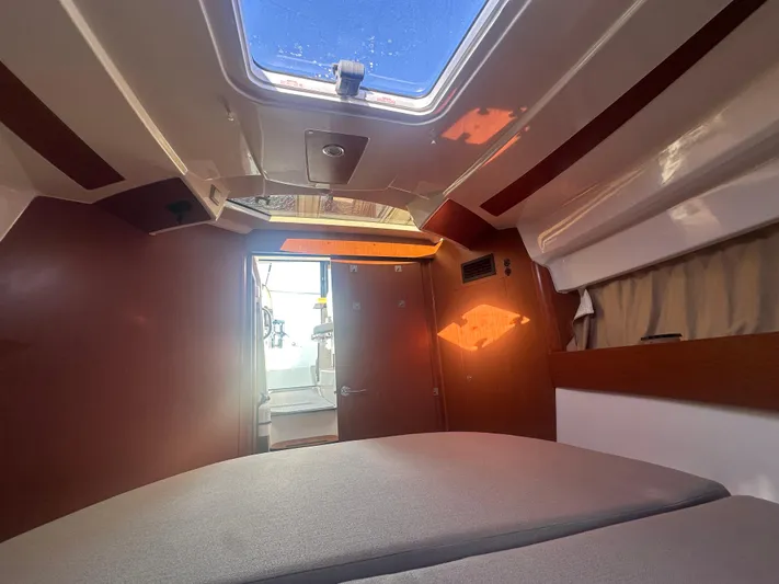 Marking Time Yacht Photos Pics Interior cabin of 2016 Jeanneau Merry Fisher 855 with skylight and wooden accents.