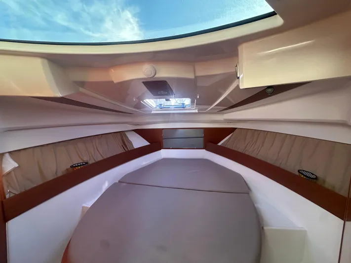 Marking Time Yacht Photos Pics Interior cabin of 2016 Jeanneau Merry Fisher 855 with skylight and cushioned seating.