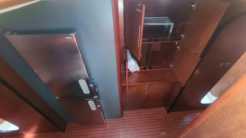 Pono Yacht Photos Pics Interior view of 2005 Fountaine Pajot FP Eleuthera 60 yacht kitchen with wooden cabinets.