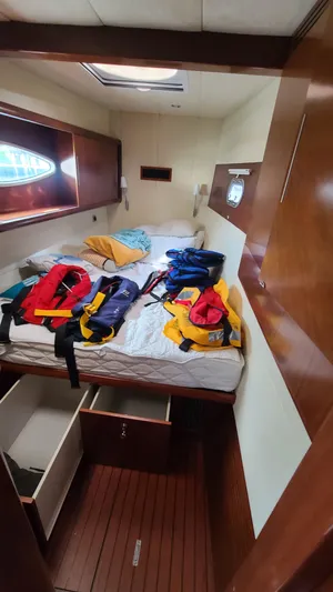 Pono Yacht Photos Pics Cabin interior of 2005 Fountaine Pajot FP Eleuthera 60 with life jackets on bed.