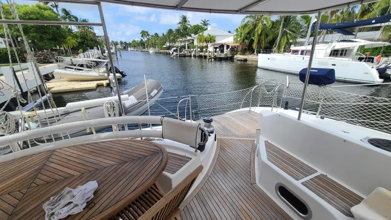 Pono Yacht Photos Pics Deck view of 2005 Fountaine Pajot FP Eleuthera 60 catamaran docked by a scenic canal.