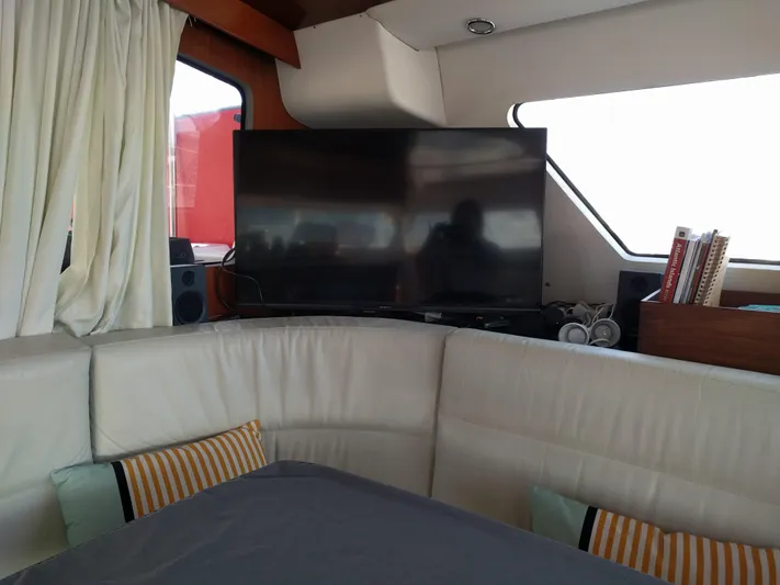 Pono Yacht Photos Pics Interior of 2005 Fountaine Pajot FP Eleuthera 60 with TV and cozy seating area.