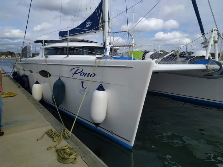 Pono Yacht Photos Pics Fountaine Pajot FP Eleuthera 60 catamaran docked, 2005 model, with fenders and ropes.