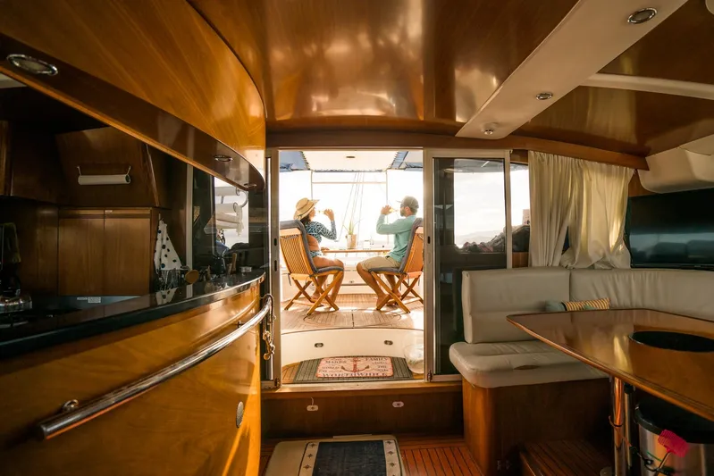 Pono Yacht Photos Pics Interior of 2005 Fountaine Pajot FP Eleuthera 60 yacht with two people relaxing outside.