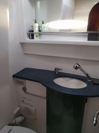 Pono Yacht Photos Pics Bathroom interior of 2005 Fountaine Pajot FP Eleuthera 60 yacht, featuring modern sink and mirror.