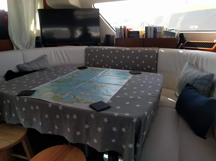 Pono Yacht Photos Pics Cozy interior of 2005 Fountaine Pajot FP Eleuthera 60 with map on star-patterned tablecloth.