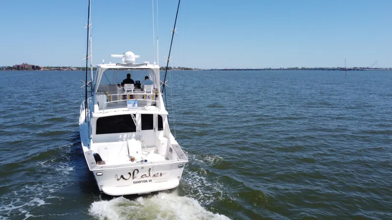 Whaler Yacht Photos Pics 1997 Ocean 48 Convertible yacht cruising on open water under clear blue sky.