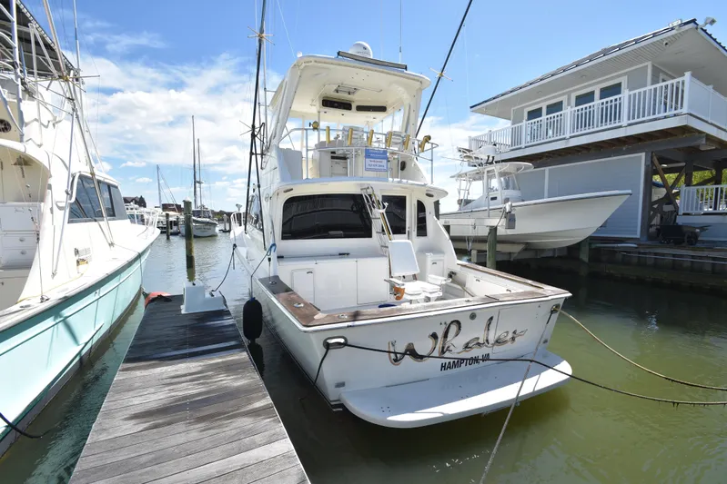 Whaler Yacht Photos Pics 1997 Ocean 48 Convertible yacht docked at marina under clear blue sky.