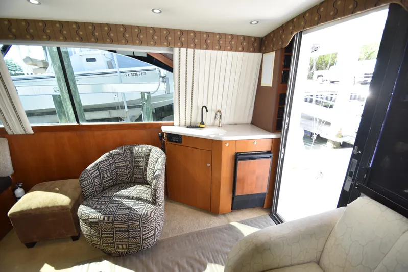 Whaler Yacht Photos Pics Interior of 1997 Ocean 48 Convertible yacht with seating, sink, and window view.
