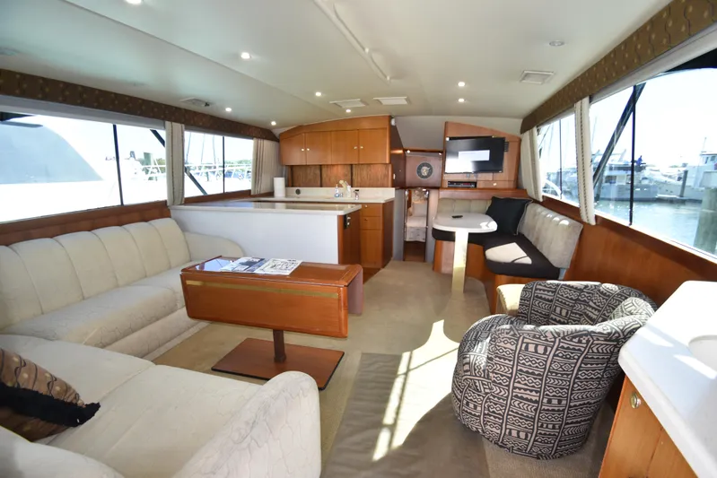Whaler Yacht Photos Pics Luxurious interior of a 1997 Ocean 48 Convertible yacht with elegant seating and modern amenities.