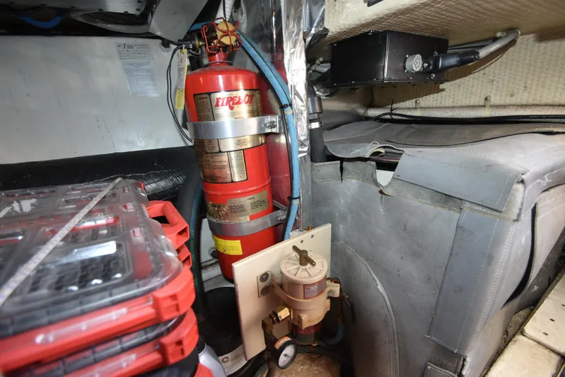 Whaler Yacht Photos Pics Engine room of 1997 Ocean 48 Convertible with fire extinguisher and equipment.
