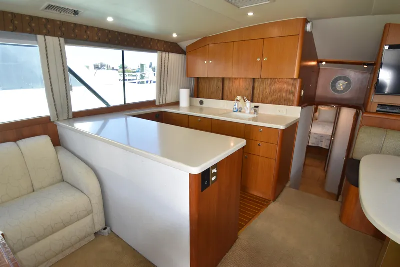 Whaler Yacht Photos Pics Interior of 1997 Ocean 48 Convertible yacht with modern kitchen and cozy seating area.
