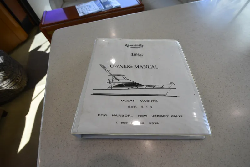 Whaler Yacht Photos Pics Owner's manual for 1997 Ocean 48 Convertible yacht on a table.