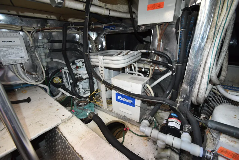 Whaler Yacht Photos Pics Engine room of a 1997 Ocean 48 Convertible boat, featuring various mechanical components and wiring.