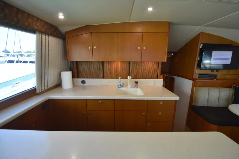 Whaler Yacht Photos Pics Interior of 1997 Ocean 48 Convertible yacht with wooden cabinets and modern amenities.