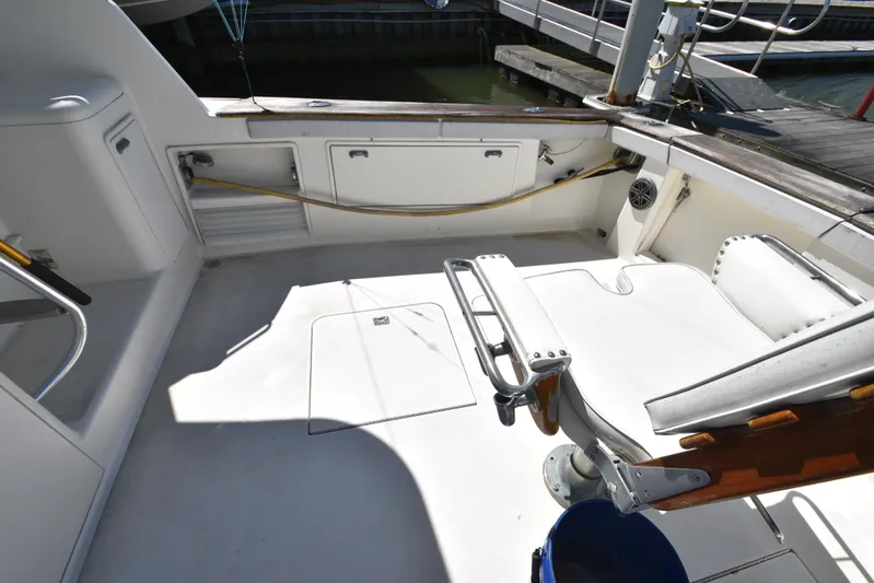 Whaler Yacht Photos Pics 1997 Ocean 48 Convertible yacht cockpit with fishing chair and storage compartments.