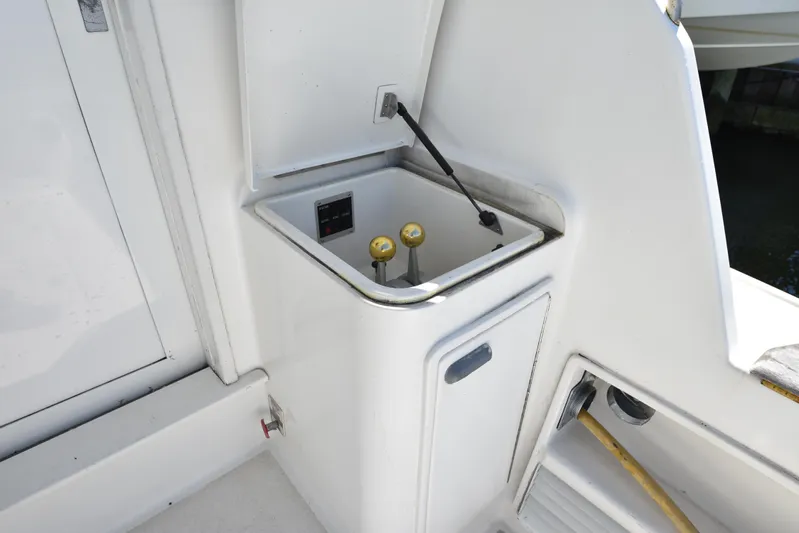 Whaler Yacht Photos Pics Control panel on 1997 Ocean 48 Convertible yacht, featuring levers and a compartment.