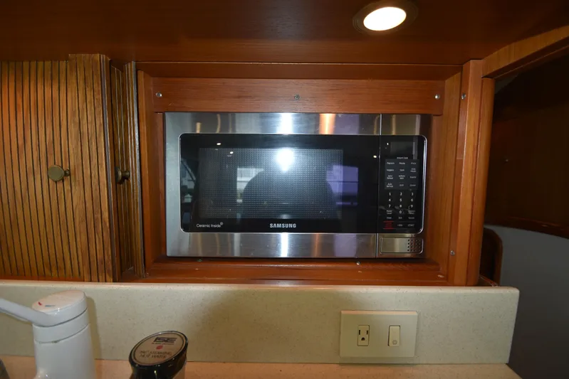 Whaler Yacht Photos Pics Built-in Samsung microwave in 1997 Ocean 48 Convertible yacht kitchen.