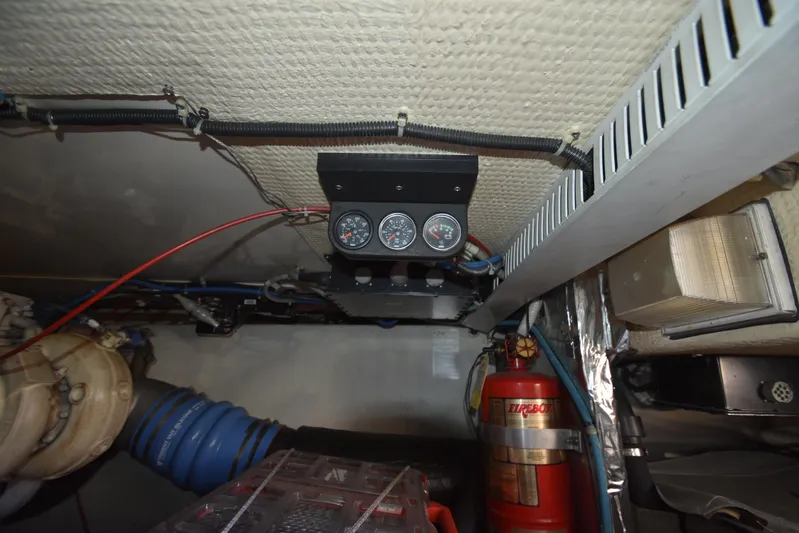Whaler Yacht Photos Pics Engine room of 1997 Ocean 48 Convertible with gauges and fire extinguisher.