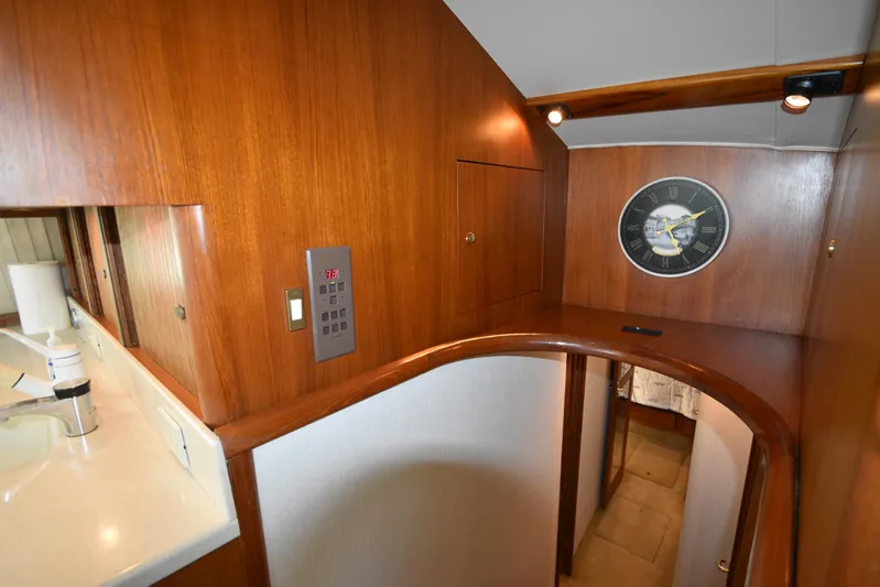 Whaler Yacht Photos Pics Interior of 1997 Ocean 48 Convertible yacht with wood paneling and wall clock.