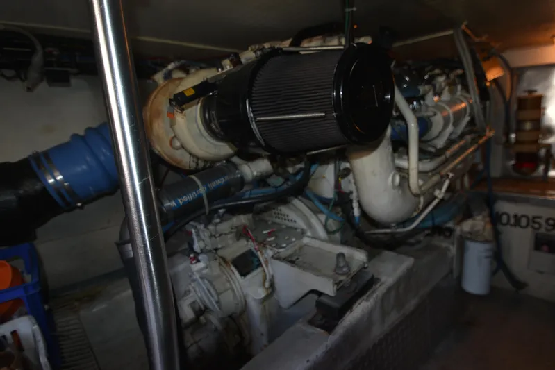 Whaler Yacht Photos Pics Engine room of a 1997 Ocean 48 Convertible yacht, showcasing mechanical components and piping.