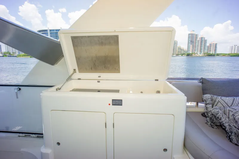  Yacht Photos Pics 2015 Ferretti Yachts 750 deck with open storage compartment, city skyline in background.