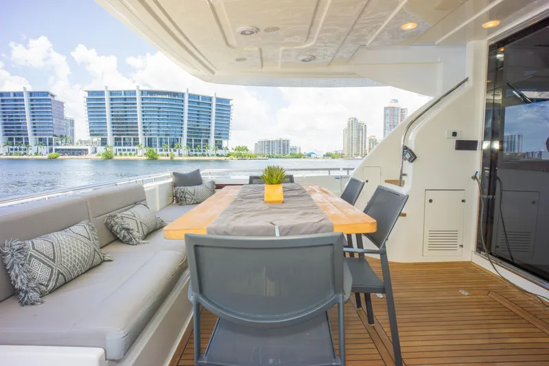  Yacht Photos Pics Outdoor dining area on 2015 Ferretti Yachts 750, featuring modern seating and waterfront view.