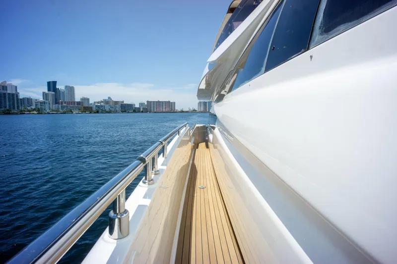  Yacht Photos Pics Side view of 2015 Ferretti Yachts 750 on water with city skyline.