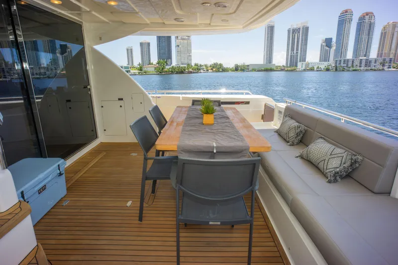  Yacht Photos Pics Luxurious 2015 Ferretti Yachts 750 deck with dining area, overlooking waterfront cityscape.