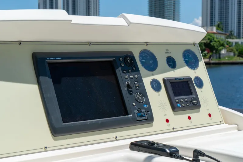  Yacht Photos Pics Control panel of a 2015 Ferretti Yachts 750 with navigation instruments and cityscape background.