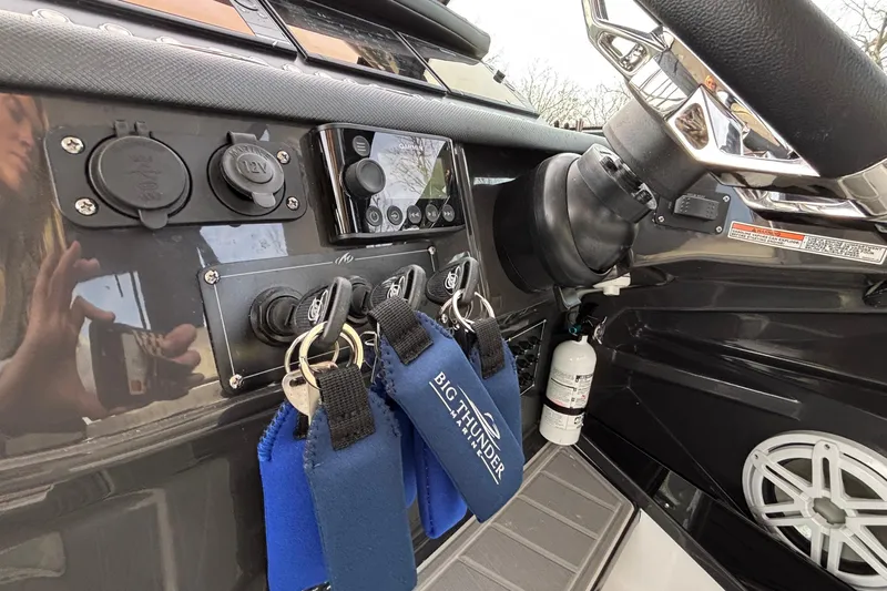  Yacht Photos Pics Control panel of 2026 Monterey 385 Super Express boat with keys and steering wheel.