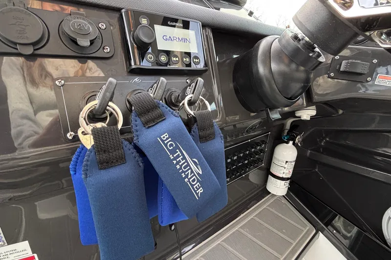  Yacht Photos Pics Control panel of 2026 Monterey 385 Super Express boat with keys and Garmin display.