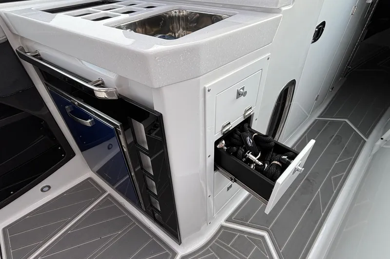  Yacht Photos Pics 2026 Monterey 385 Super Express boat interior with open storage drawer and sink.