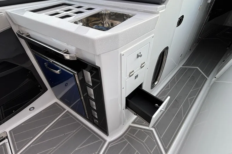  Yacht Photos Pics 2026 Monterey 385 Super Express boat interior with sink, storage, and sleek design.