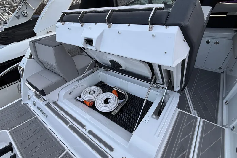  Yacht Photos Pics 2026 Monterey 385 Super Express boat with open storage compartment and coiled hoses.