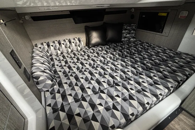  Yacht Photos Pics 2026 Monterey 385 Super Express cabin with geometric-patterned bedding and modern design.