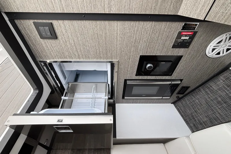  Yacht Photos Pics 2026 Monterey 385 Super Express interior with fridge, microwave, and control panel.